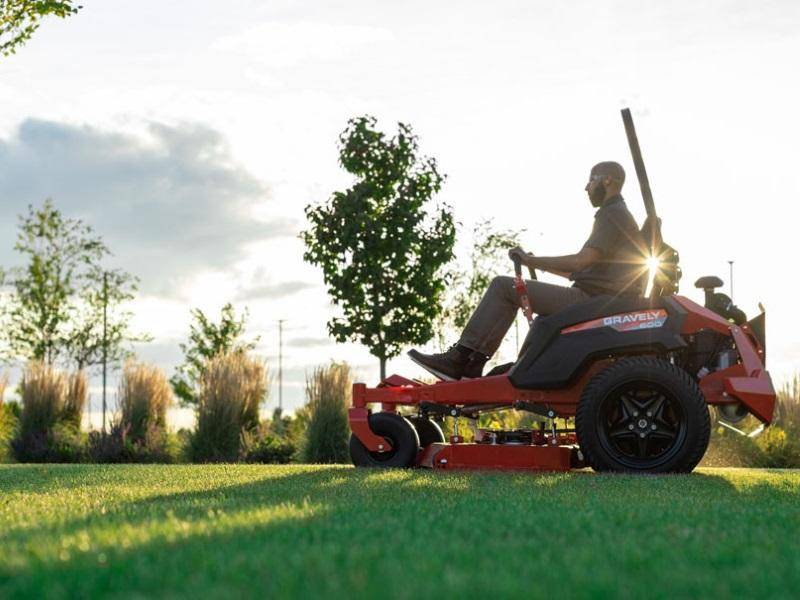 Resident cutting grass efficiently with a riding mower.