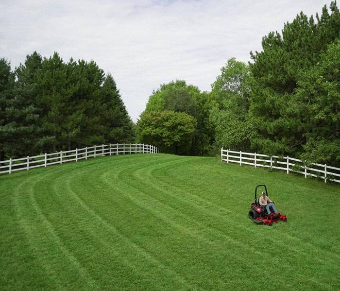 Adult man engaging in lawn care with a powerful gas-powered mower.